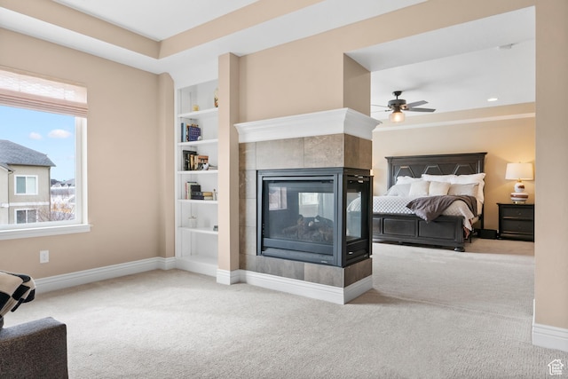 bedroom with carpet, a tile fireplace, and baseboards