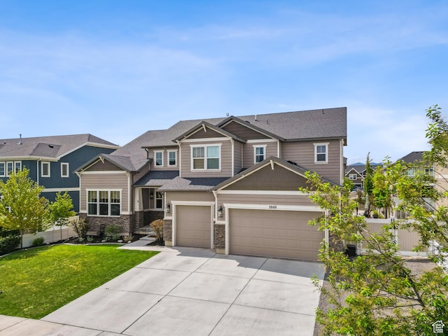 craftsman inspired home with concrete driveway, a garage, and stone siding