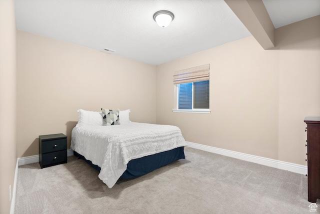 bedroom with baseboards, visible vents, and carpet