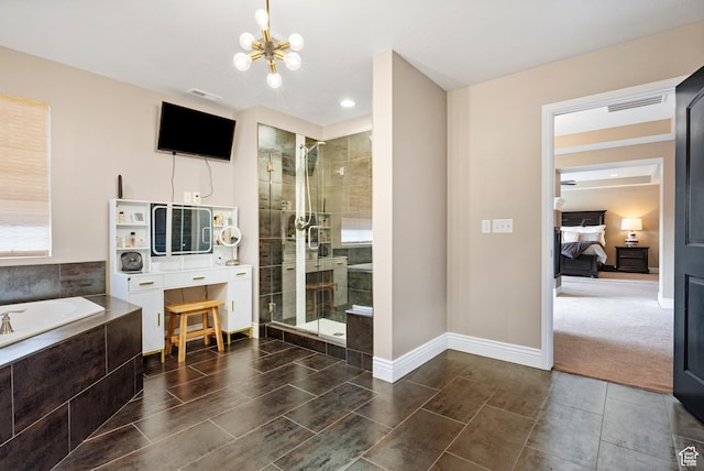 ensuite bathroom featuring a chandelier, a stall shower, a bath, and baseboards