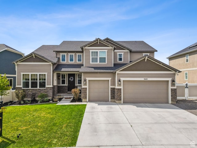 craftsman house featuring concrete driveway and stone siding