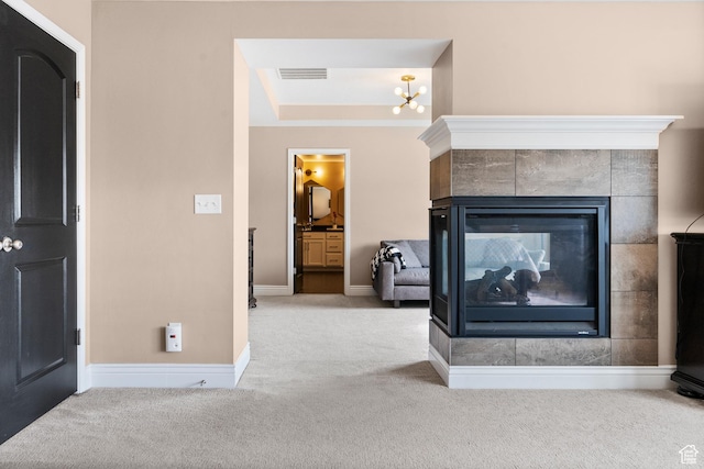 room details with baseboards, carpet flooring, visible vents, and a multi sided fireplace