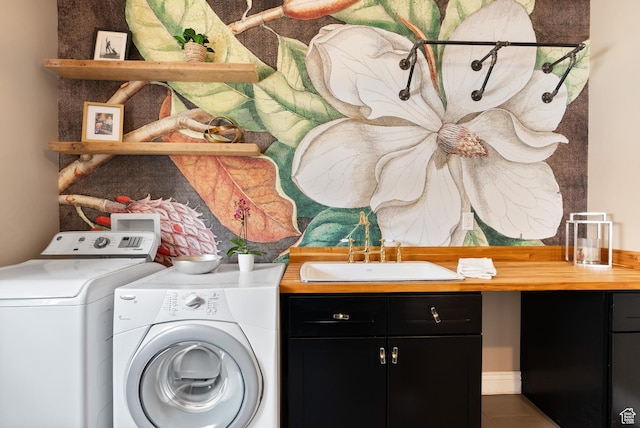 laundry room featuring cabinet space, washing machine and dryer, and tile patterned floors