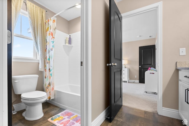 bathroom featuring toilet, shower / bath combo with shower curtain, wood finished floors, vanity, and baseboards