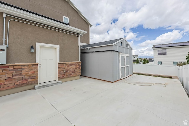 5436 W 9120 S, West Jordan, UT 84081 - view of patio / terrace featuring an outbuilding, a storage shed, and fence