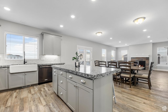 5436 W 9120 S, West Jordan, UT 84081 - kitchen featuring dishwashing machine, a sink, gray cabinets, light wood-style flooring, and recessed lighting