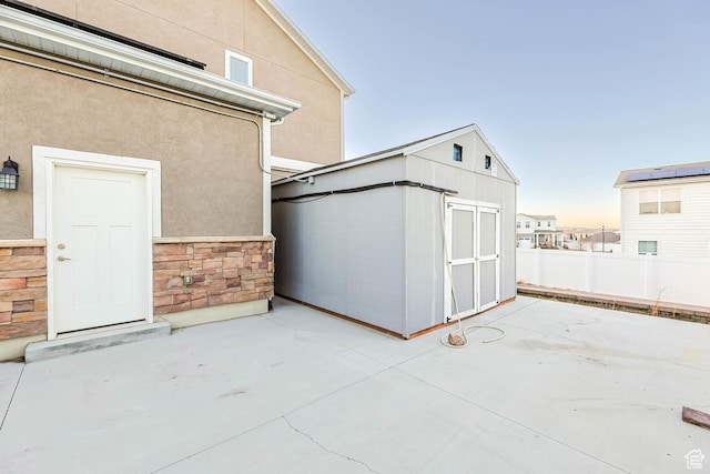 5436 W 9120 S, West Jordan, UT 84081 - view of patio / terrace with a storage unit, an outbuilding, and fence