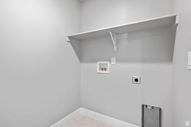 clothes washing area featuring laundry area, hookup for a washing machine, electric dryer hookup, and baseboards