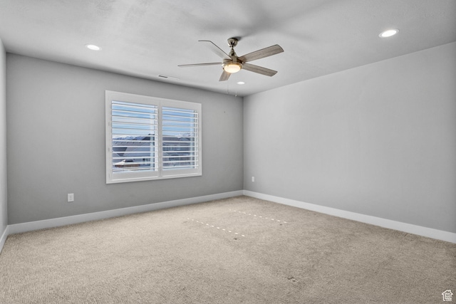 carpeted empty room featuring recessed lighting, visible vents, baseboards, and ceiling fan