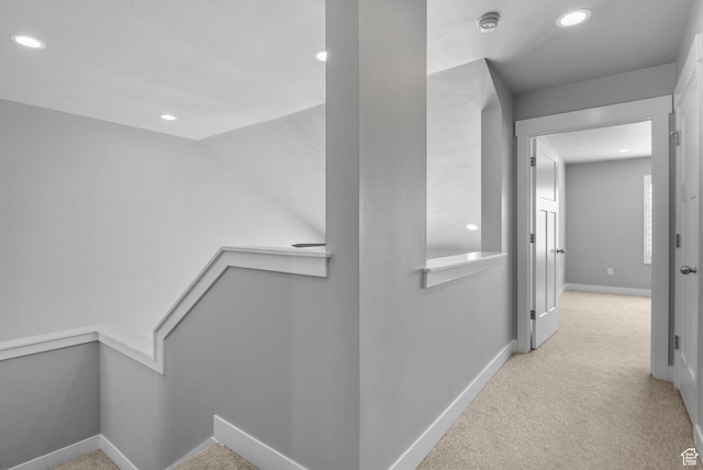 corridor featuring recessed lighting, baseboards, an upstairs landing, and carpet floors