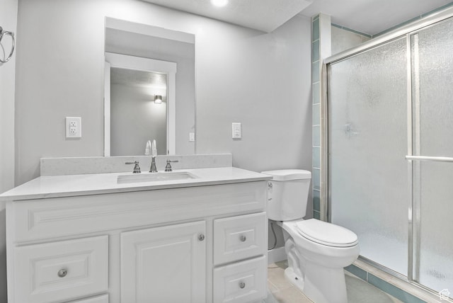 full bathroom with tile patterned floors, a stall shower, toilet, and vanity