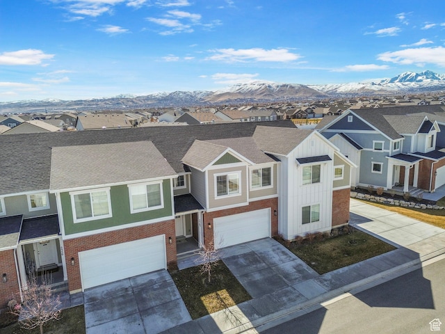 view of front of home featuring a mountain view, a residential view, and driveway