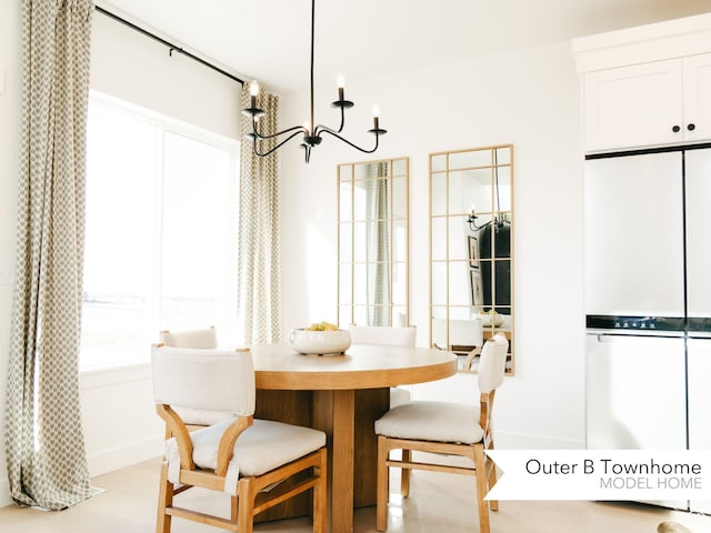 dining space featuring light wood-style floors and a chandelier