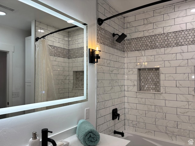 full bath featuring visible vents, a sink, and shower / bathtub combination with curtain