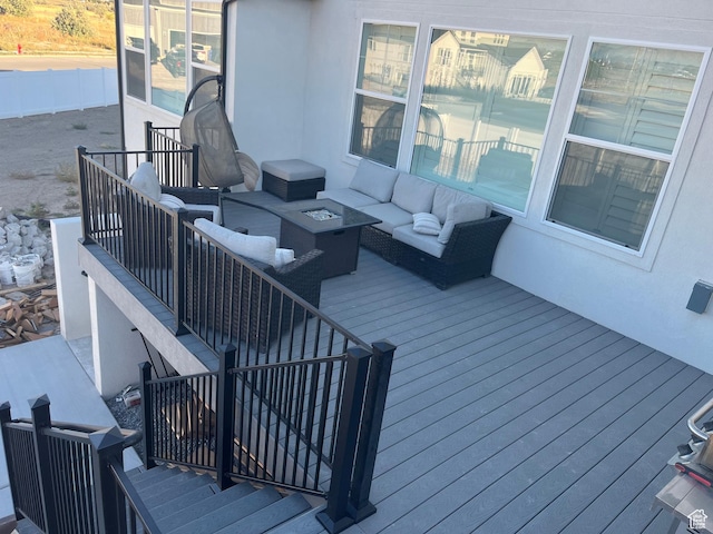 wooden terrace featuring stairs and an outdoor living space with a fire pit