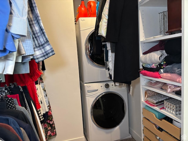 laundry room with stacked washer and dryer and laundry area