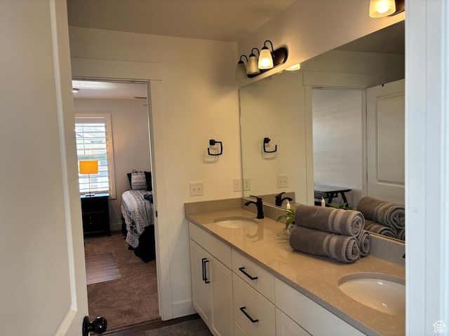 ensuite bathroom featuring ensuite bath, a sink, and double vanity