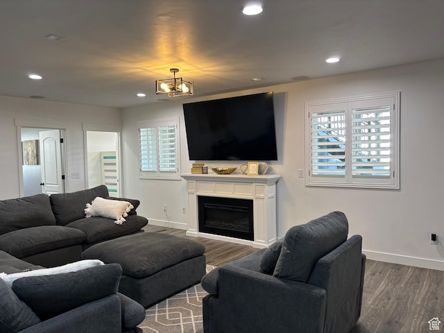 living area with wood finished floors, a healthy amount of sunlight, and baseboards