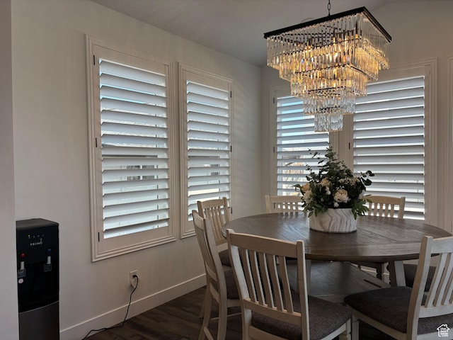 dining room with wood finished floors, baseboards, and a notable chandelier