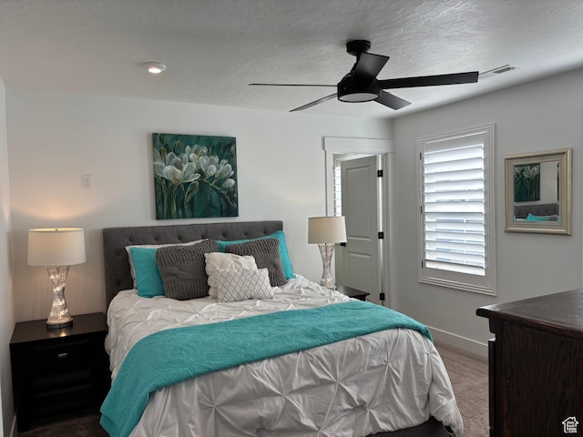 carpeted bedroom featuring visible vents, baseboards, and ceiling fan