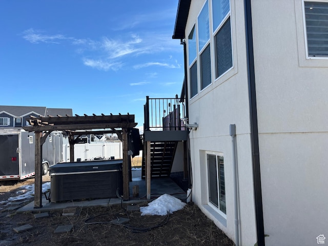 view of yard featuring a pergola, a hot tub, a patio, and stairs
