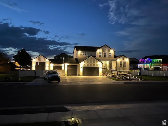modern farmhouse featuring board and batten siding, an attached garage, and driveway