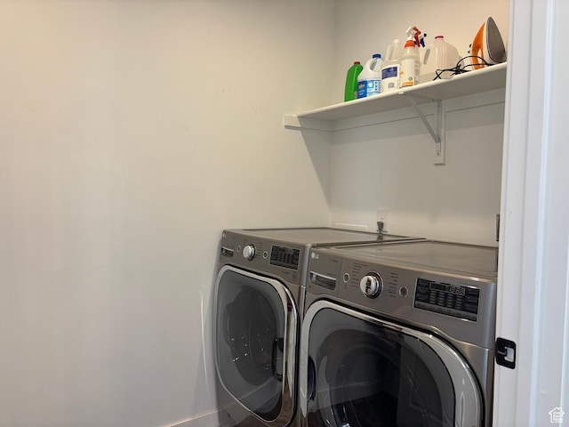 clothes washing area with independent washer and dryer and laundry area