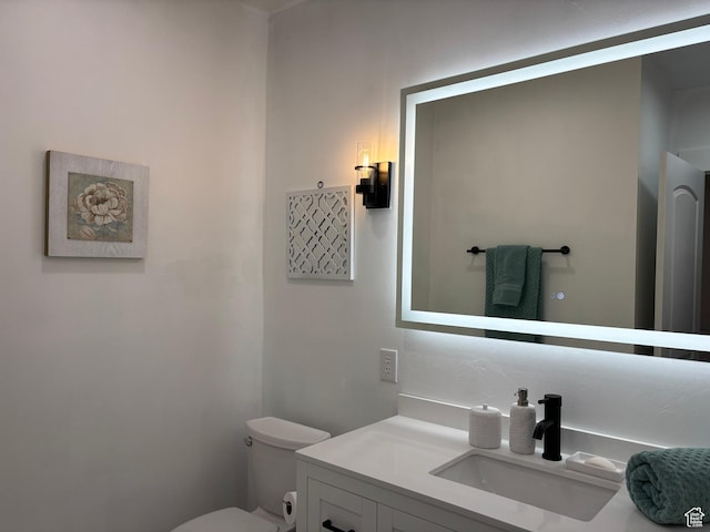 bathroom featuring toilet and vanity