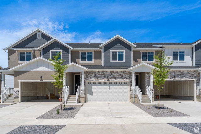 706 W 4500 S Unit 307, Mapleton, UT 84664 - view of front of property featuring board and batten siding, concrete driveway, stone siding, and an attached garage