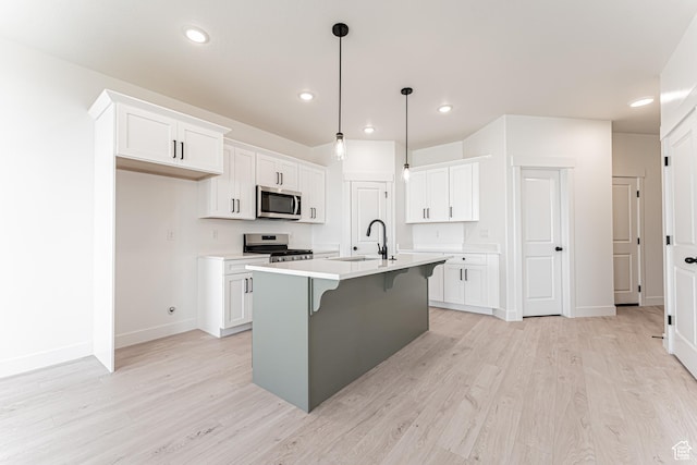 706 W 4500 S Unit 307, Mapleton, UT 84664 - kitchen with stainless steel appliances, a sink, baseboards, light wood-style flooring, and recessed lighting