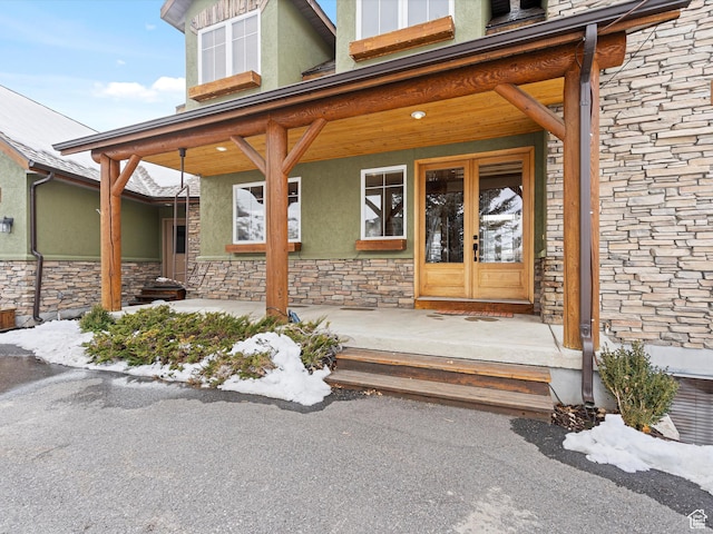 1173 S Innsbruck Dr, Huntsville, UT 84317 - property entrance featuring covered porch, stone siding, stucco siding, and french doors