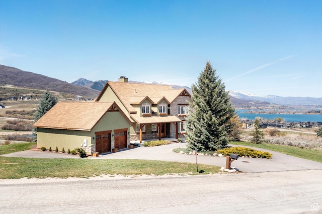 1173 S Innsbruck Dr, Huntsville, UT 84317 - view of front of house with a chimney, stone siding, a front lawn, concrete driveway, and an attached garage