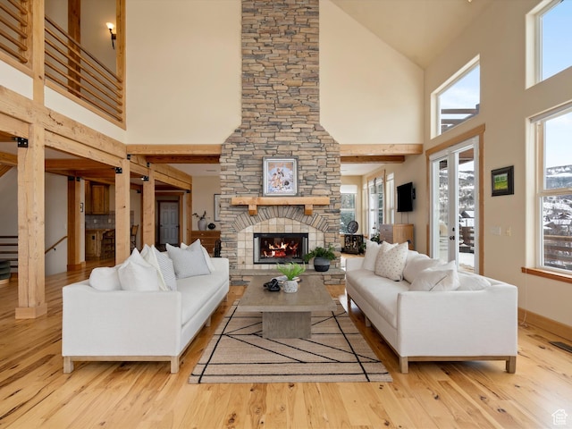 1173 S Innsbruck Dr, Huntsville, UT 84317 - living room with high vaulted ceiling, a stone fireplace, a wealth of natural light, and wood finished floors
