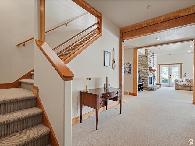 1173 S Innsbruck Dr, Huntsville, UT 84317 - stairway featuring beamed ceiling, a fireplace, carpet floors, baseboards, and french doors