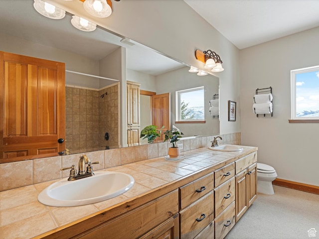 1173 S Innsbruck Dr, Huntsville, UT 84317 - bathroom featuring toilet, a tile shower, double vanity, and a sink