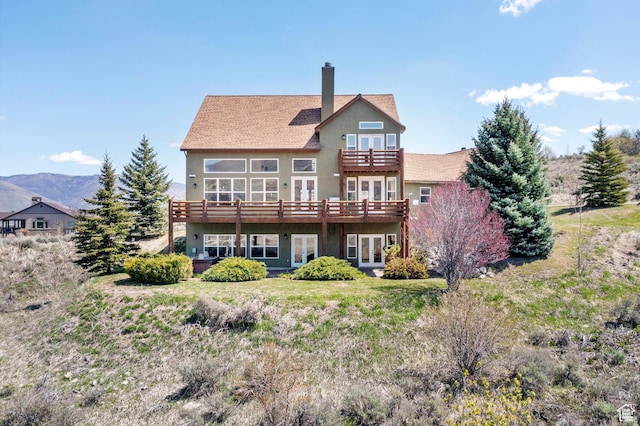 1173 S Innsbruck Dr, Huntsville, UT 84317 - back of house featuring a wooden deck, a balcony, a chimney, stucco siding, and french doors