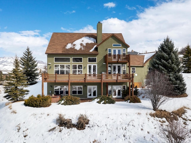1173 S Innsbruck Dr, Huntsville, UT 84317 - snow covered property featuring a chimney, french doors, a balcony, and stucco siding