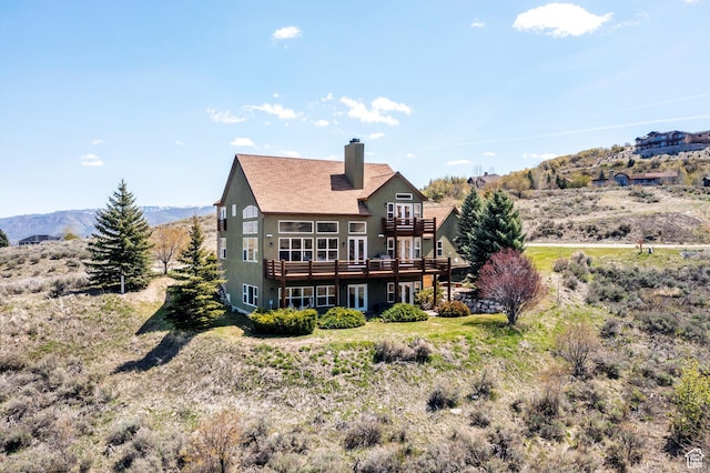 1173 S Innsbruck Dr, Huntsville, UT 84317 - rear view of property with a chimney, a wooden deck, stucco siding, and a balcony