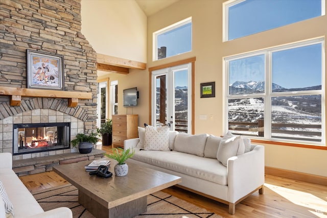 1173 S Innsbruck Dr, Huntsville, UT 84317 - living area with a stone fireplace, a wealth of natural light, and wood finished floors