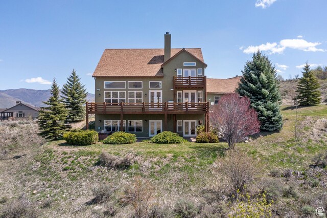 1173 S Innsbruck Dr, Huntsville, UT 84317 - back of property featuring a balcony, a deck, a chimney, stucco siding, and french doors