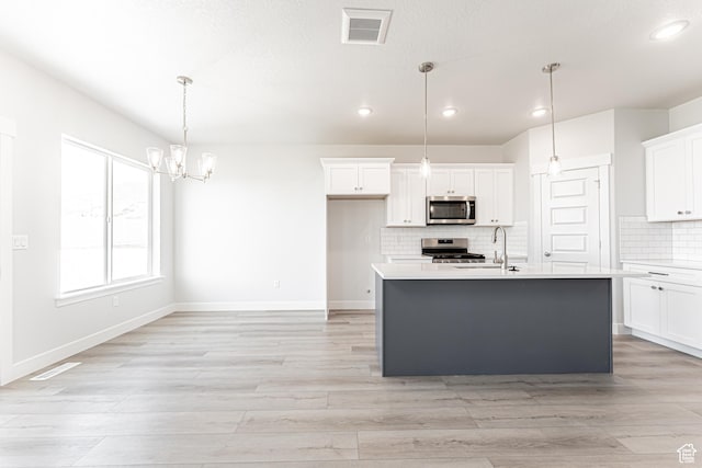 702 W 4500 S Unit 308, Mapleton, UT 84664 - kitchen featuring appliances with stainless steel finishes, recessed lighting, light countertops, white cabinetry, and backsplash
