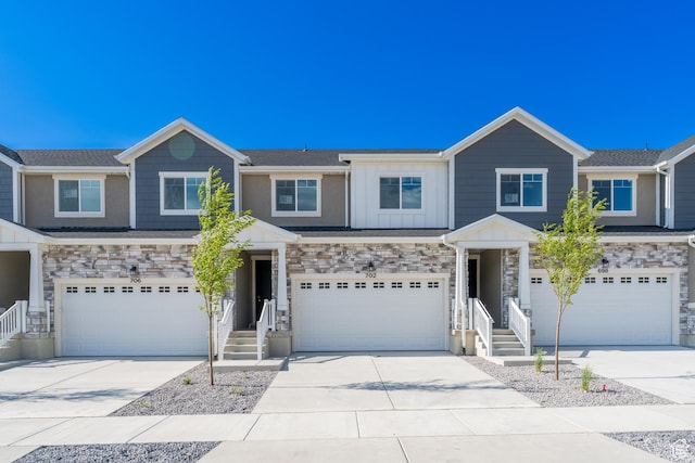 702 W 4500 S Unit 308, Mapleton, UT 84664 - view of front of house with a garage, stone siding, board and batten siding, and concrete driveway