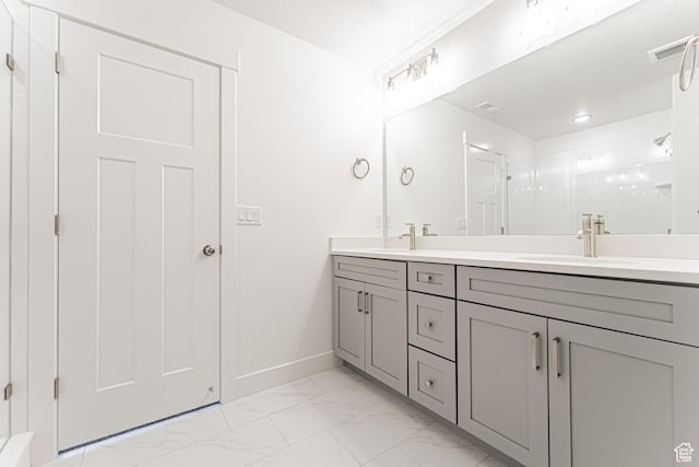 698 W 4500 S Unit 309, Mapleton, UT 84664 - bathroom featuring double vanity, marble look tiles, baseboards, and a shower with shower door