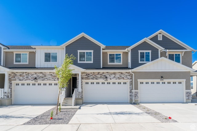 698 W 4500 S Unit 309, Mapleton, UT 84664 - view of front of property featuring concrete driveway, board and batten siding, an attached garage, and stone siding