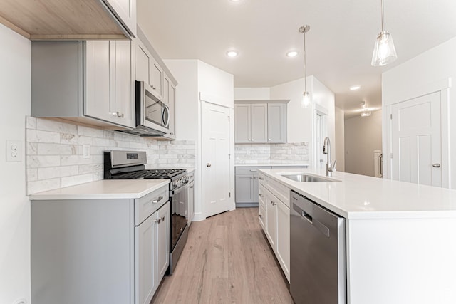 698 W 4500 S Unit 309, Mapleton, UT 84664 - kitchen with stainless steel appliances, a sink, light wood-type flooring, light countertops, and gray cabinets