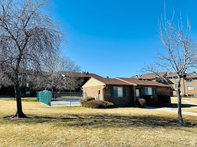 4110 S Oak Meadows Dr Unit 20, Taylorsville, UT 84123 - view of front of house with brick siding, a front lawn, and fence
