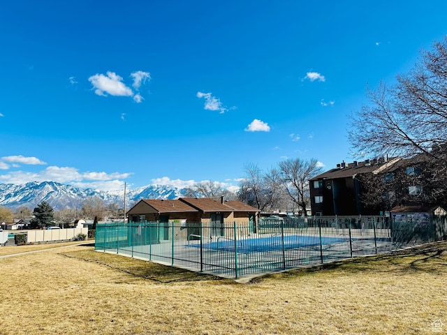 4110 S Oak Meadows Dr Unit 20, Taylorsville, UT 84123 - view of sport court featuring a mountain view, a yard, fence, and a community pool