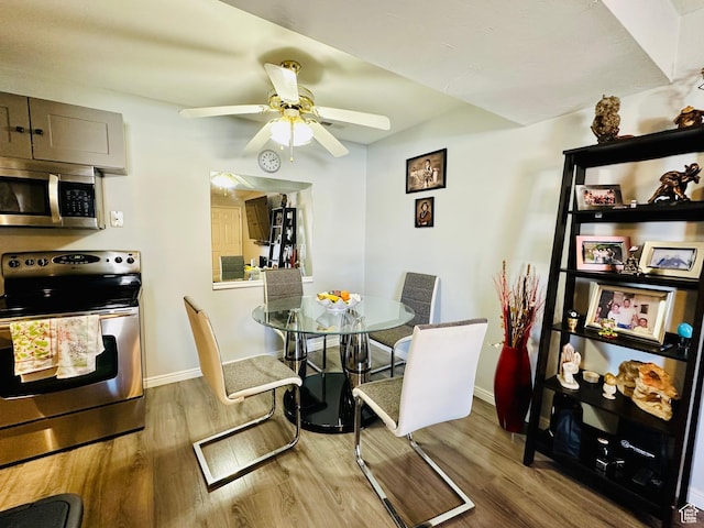 4110 S Oak Meadows Dr Unit 20, Taylorsville, UT 84123 - dining area with wood finished floors, a ceiling fan, and baseboards