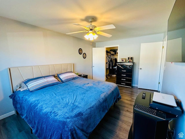 4110 S Oak Meadows Dr Unit 20, Taylorsville, UT 84123 - bedroom with dark wood-style floors, a walk in closet, a closet, a ceiling fan, and baseboards