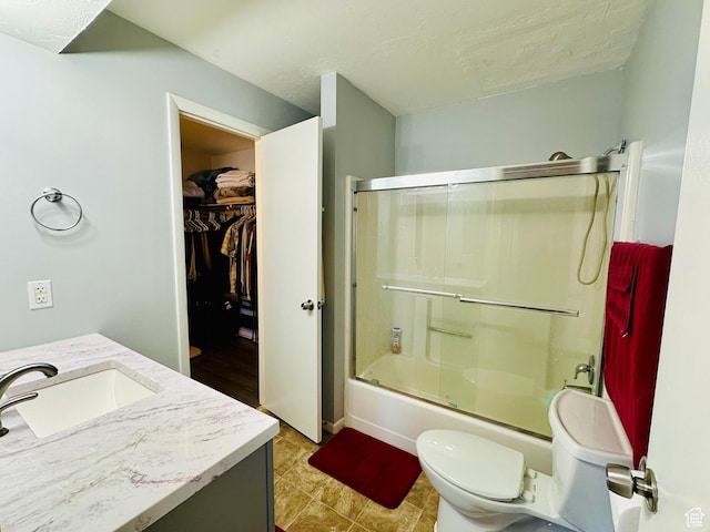 4110 S Oak Meadows Dr Unit 20, Taylorsville, UT 84123 - full bathroom with a spacious closet, shower / bath combination with glass door, vanity, and toilet